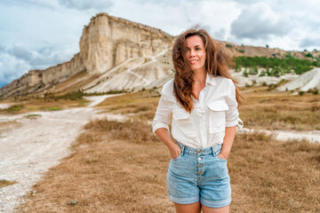 A young woman at the foot of the White Rock in the Crimea. Beautiful travel concept