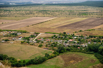 Panoramic view from the height of the White Rock in Crimea and green valley. Blue sky, a small village at the bottom