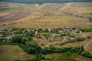 Panoramic view from the height of the White Rock in Crimea and green valley. Blue sky, a small village at the bottom