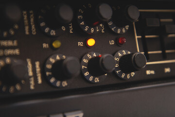 Guitar amplifier in recording studio, work on music in progress: yellow button shine, switches are configured