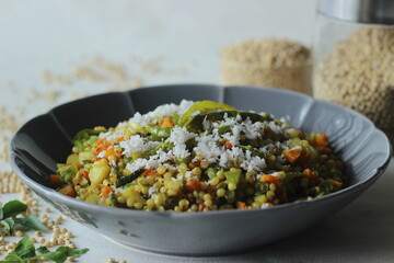Sorghum upma. A South Indian breakfast dish with whole Sorghum and vegetables. Toped with grated...
