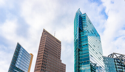 Futuristic high-rise commercial office buildings rise behind train station building on Potsdamer Platz