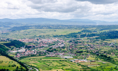 Fototapeta premium Panorama top view of the city Toplita in Romania. Mountains view.