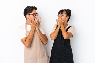 Restaurant mixed race waiters isolated on white background is a little bit nervous and scared putting hands to mouth