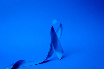Prostate care. Awareness of men health in November with blue prostate cancer ribbon isolated on...