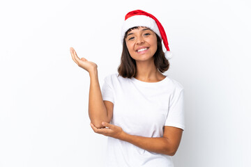 Young mixed race woman celebrating Christmas isolated on white background extending hands to the side for inviting to come