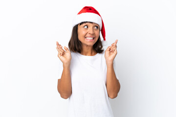 Young mixed race woman celebrating Christmas isolated on white background with fingers crossing