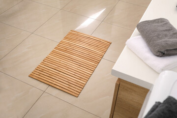 Wooden mat on floor in bathroom. Interior design