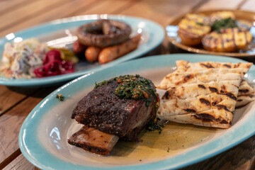 assorted dishes with potatoes, baked ribs and sausages, dishes in the restaurant