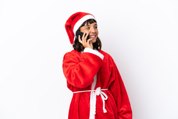 Young mixed race woman disguised as Santa Claus isolated on white background keeping a conversation with the mobile phone