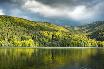 Picturesque landscape with clear lake and autumn forest on his coast. Tereblia-Ritske Reservoir (Vilshanske) on Tereblia river, Transcarpathian region, Ukraine