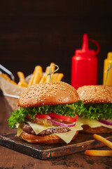 Appetizing homemade burger with beef, cheese and onion marmalade close-up. Fast food concept, american food