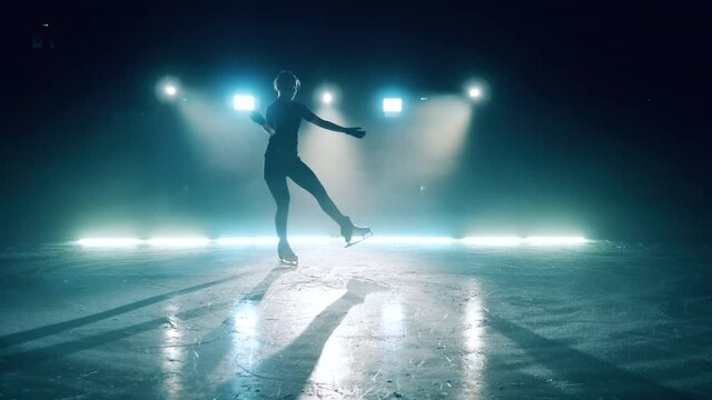 Young lady is practicing ice skating and doing spins