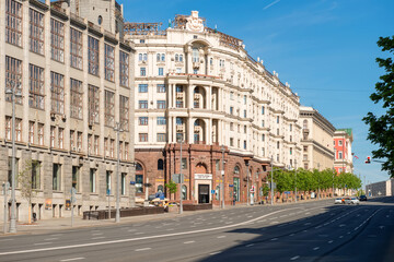 Fototapeta na wymiar Moscow, View on Tverskaya Street. Russian neoclassical & eclectic architecture and urban car traffic on an early summer morning
