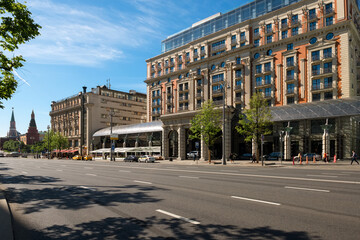 Fototapeta premium Moscow, View on Tverskaya Street and the Ritz-Carlton hotel. Russian neoclassical & eclectic architecture and urban car traffic on an early summer morning