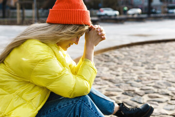 Stylish gor; wearing yellow puffer and orange knitted hat