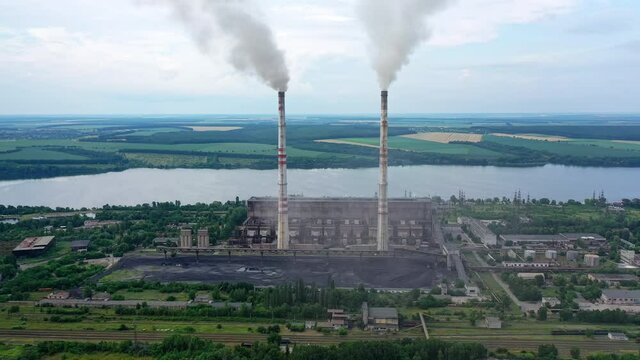 Huge factory producing electricity. Aerial Shot of polluting coal fired power reactors.
