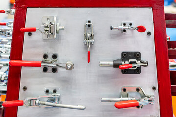 Fototapeta premium Various type metal toggle clamp or quick lock e.g. pull push latch vertical horizontal handle clamp etc. for manufacturing process in industrial