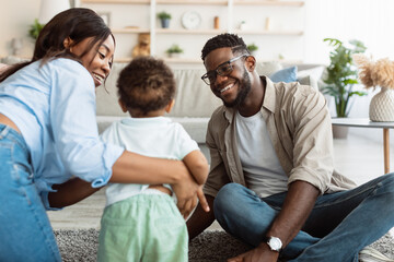 Portrait of happy black family smiling playing at home