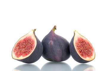 Two half and one whole ripe sweet figs, close-up, isolated on white.
