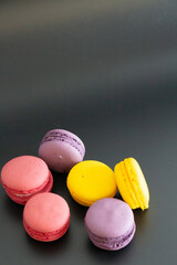 colorful macarons on black background