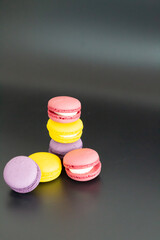 colorful macarons on black background