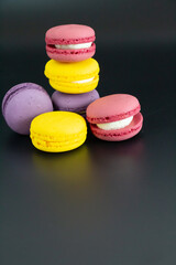 colorful macarons on black background