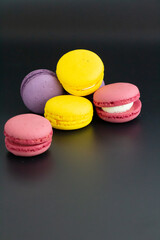 colorful macarons on black background