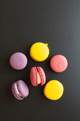 colorful macarons on black background