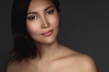 Fototapeta premium Portrait of young and beautiful asian woman on gray background