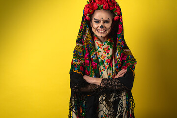 girl in the image of Kalavera Katrina close up showing various emotional body gestures, in a headscarf, on a yellow background. Dia-de -los -muertos. Day of death. Halloween.