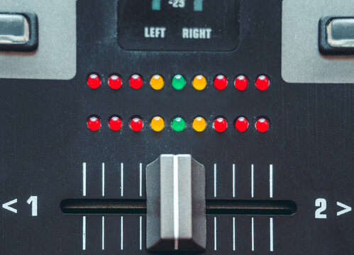 Detailed close-up of a crossfader on a DJ mixer. 