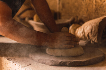 Manufacturer of handmade clay pots working in his workshop to create traditional Mexican kitchen utensils, such as saucepans, casseroles, vases.