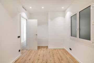 Empty room with window and hardwood floor after renovation. Modern style new interior.
