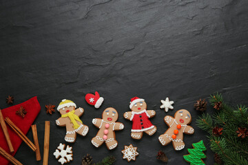 Flat lay composition with delicious Christmas cookies on black table, space for text