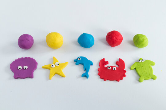 Making colorful sea animal shapes like fish , crab with play dough.
