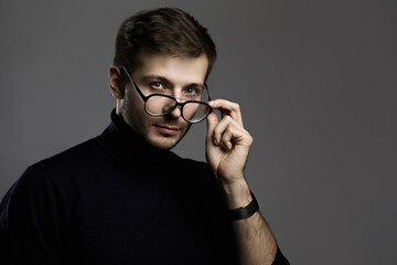 Fototapeta na wymiar Young intelligent man wearing turtleneck and eyeglasses