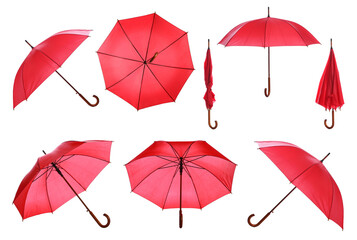 Set with stylish red umbrellas on white background