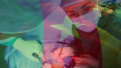 Animation of flag of cameroon waving over surgeons in operating theatre - Powered by Adobe