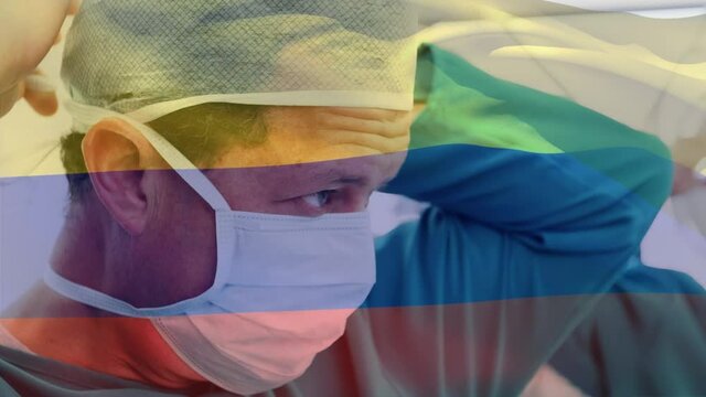 Animation of flag of colombia waving over surgeons in operating theatre