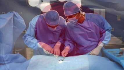 Animation of flag of japan waving over surgeons in operating theatre - Powered by Adobe