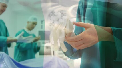 Animation of flag of nigeria waving over surgeons in operating theatre - Powered by Adobe