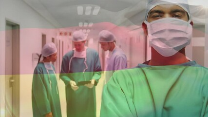 Animation of flag of germany waving over surgeons in operating theatre - Powered by Adobe