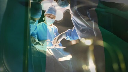 Animation of flag of nigeria waving over surgeons in operating theatre - Powered by Adobe