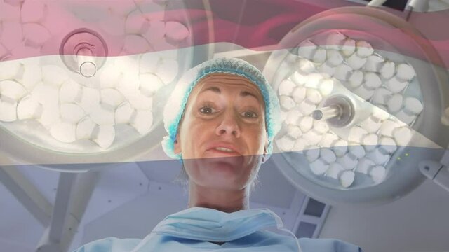 Animation of flag of netherlands waving over surgeon in operating theatre