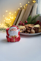 cozy christmas decoration and tasty snacks on table. Christmas and New Year Holiday concept. festive winter season. home hygge atmosphere