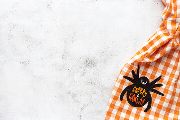 Fototapeta na wymiar Checked tablecloth with Halloween picture on grey background
