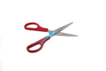 Red used scissors with paint splatter isolated on white background