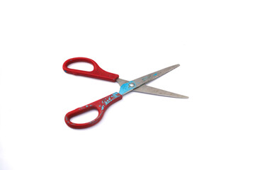 Red used scissors with paint splatter isolated on white background