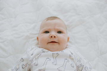 cute baby portrait at home on bed
